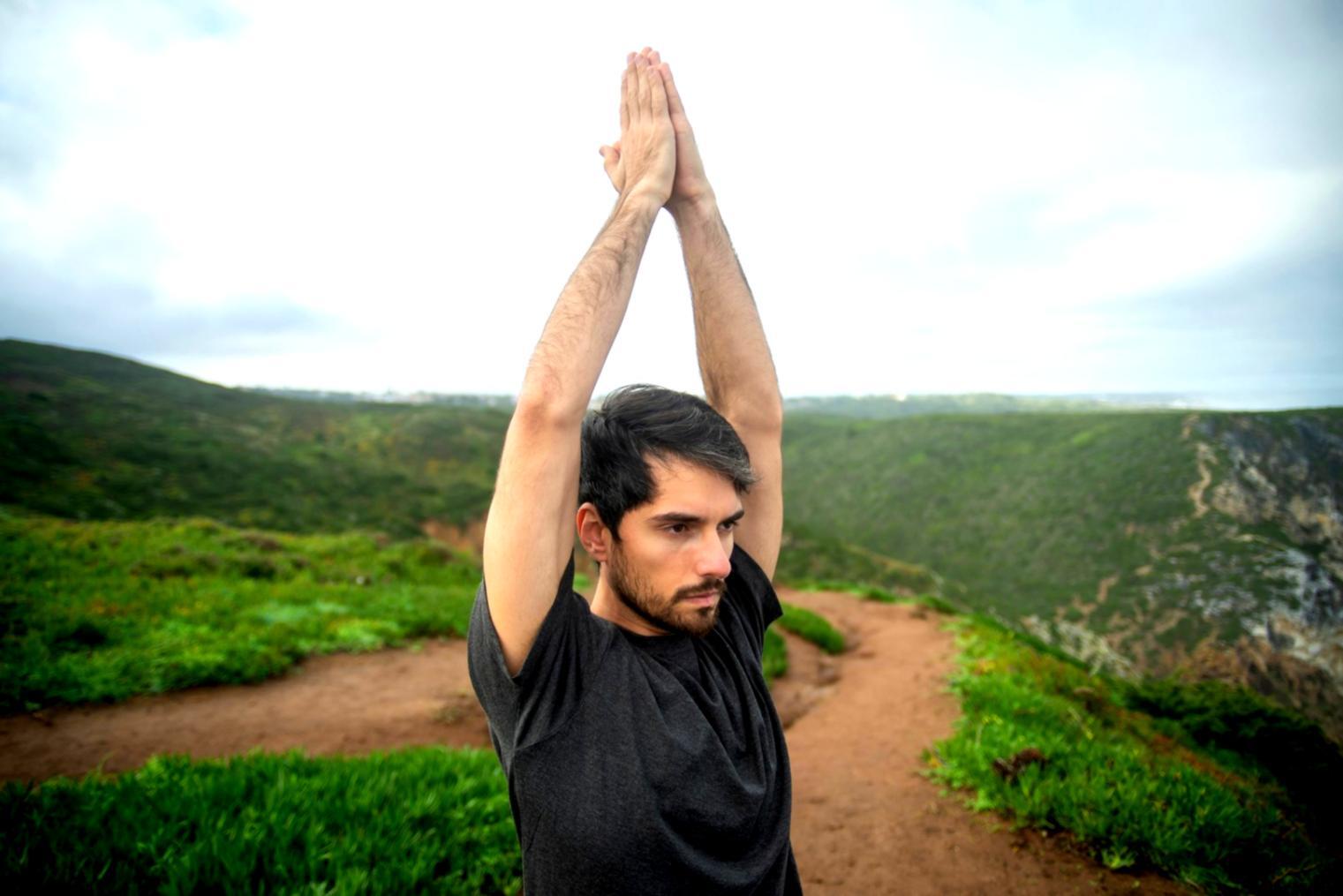 Estudiante practicando posturas de yoga de fortalecimiento en ambiente natural
